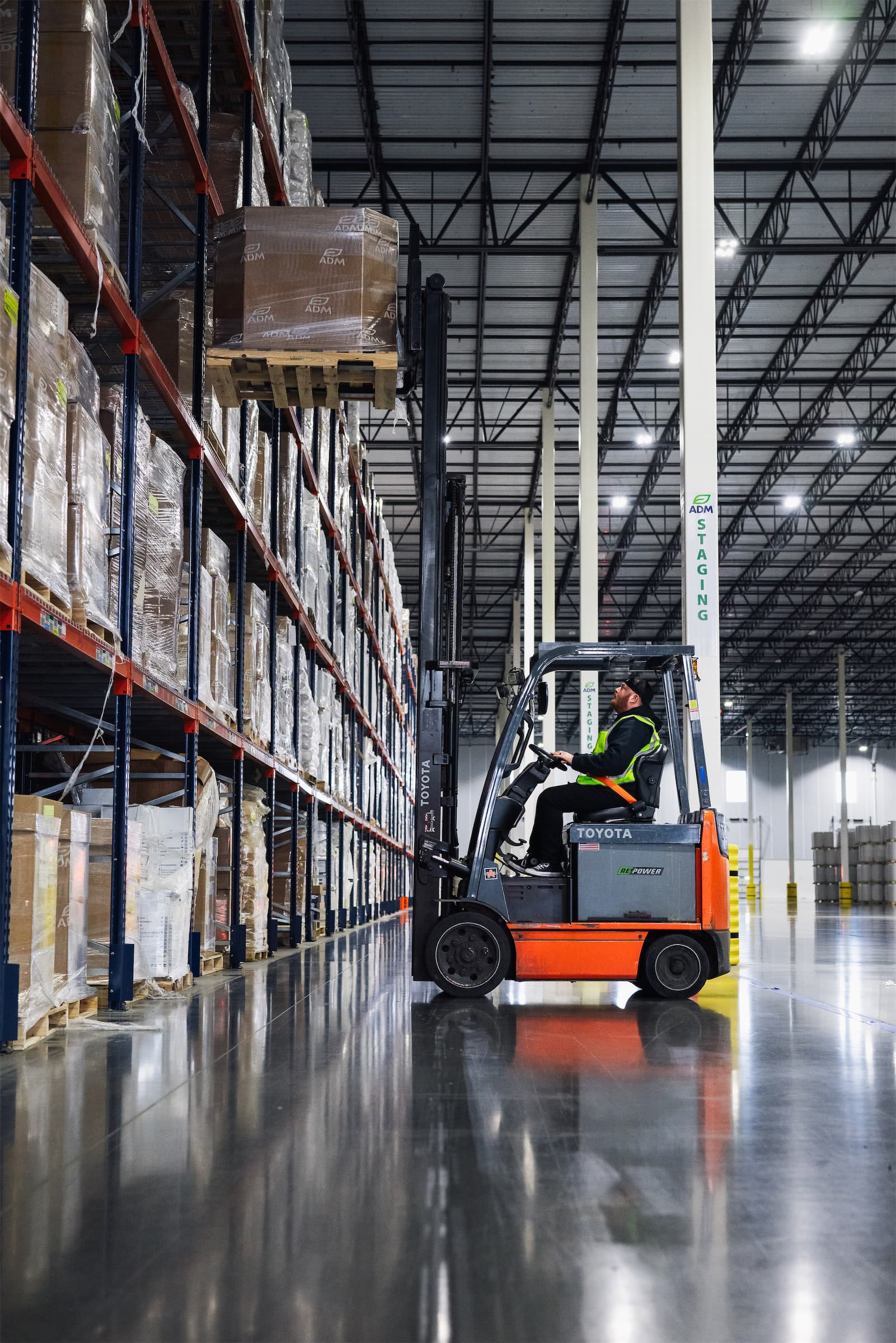 Forklift operator pulling a pallet from the rack