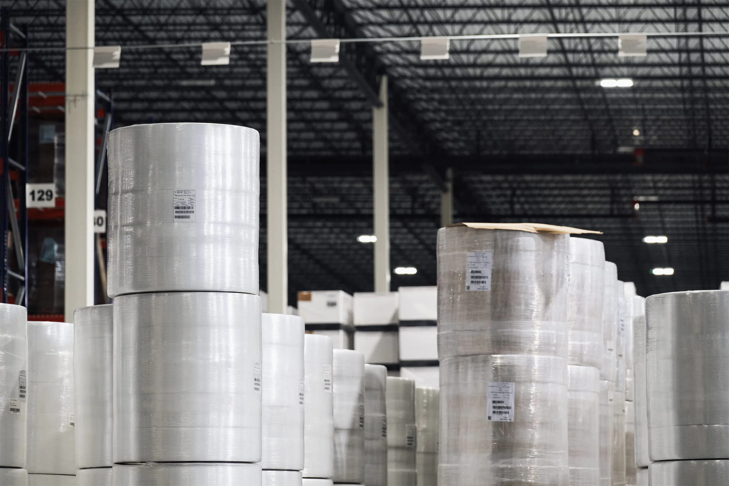 Tall stacks of rolls of packaging material